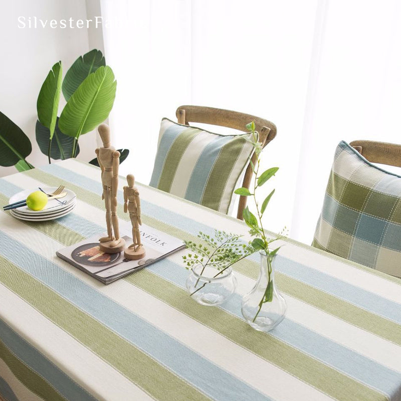 green striped farmhouse tablecloth draped over rectangle table