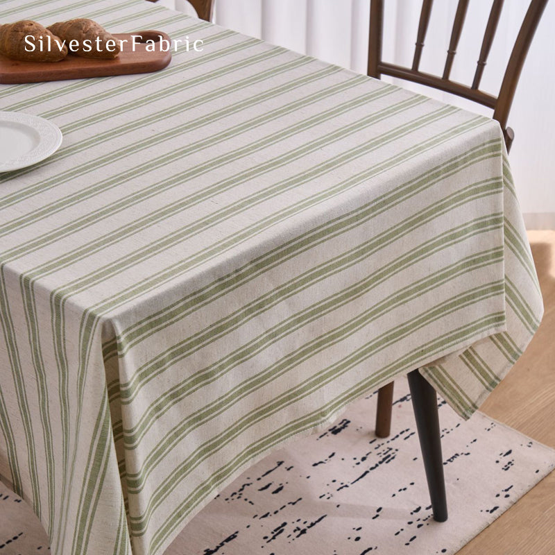 green striped farmhouse tablecloth laid flat on dining table