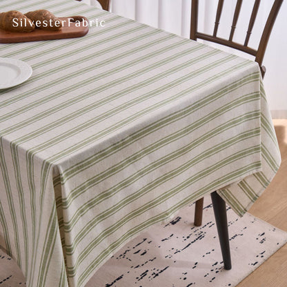 green striped farmhouse tablecloth laid flat on dining table