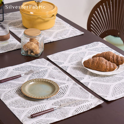 grey textured farmhouse placemats laid flat on dining table