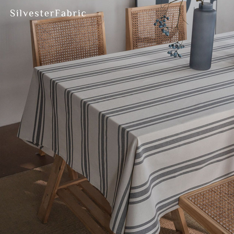 grey farmhouse striped tablecloth laid flat on dining table