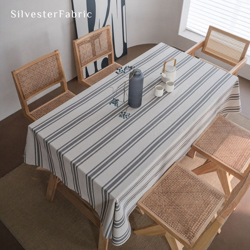 grey farmhouse striped tablecloth draped over rectangle table