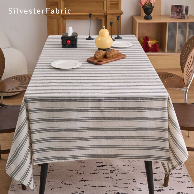 grey striped farmhouse tablecloth draped over rectangle table
