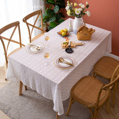 The rectangle table was covered with a white lace tablecloth