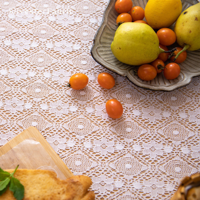 The rectangle table was covered with a white lace tablecloth