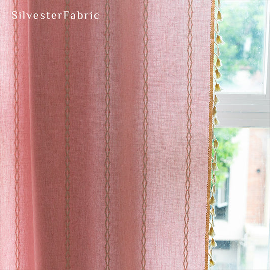 Light pink curtains hanging in the bedroom window