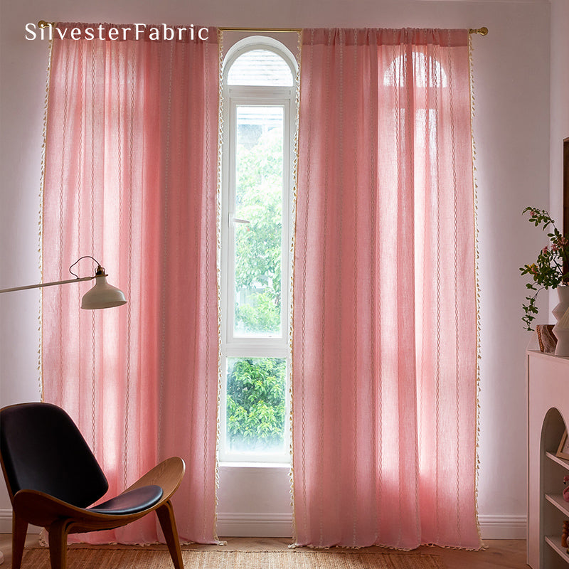 Light pink curtains hanging in the bedroom window