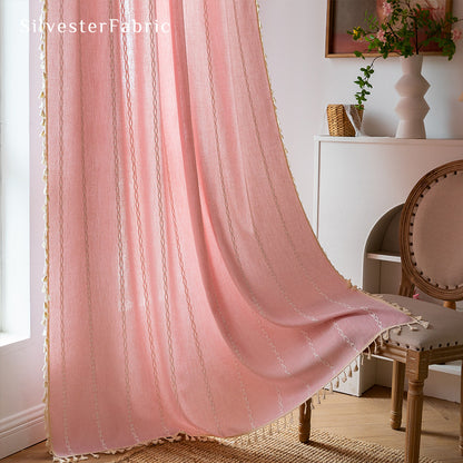 Light pink curtains hanging in the bedroom window