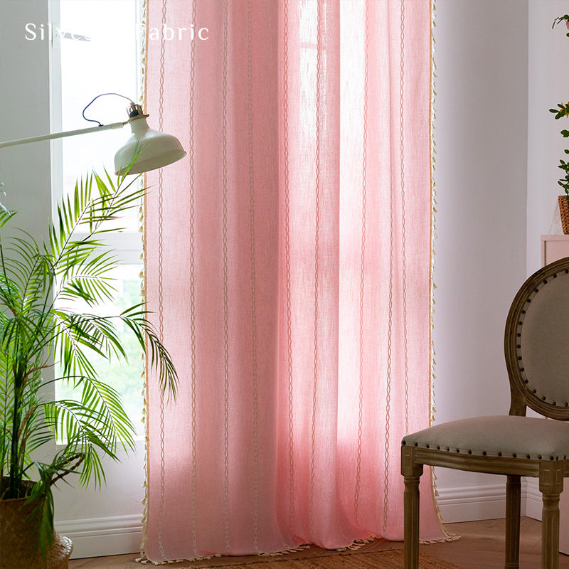 Light pink curtains hanging in the bedroom window