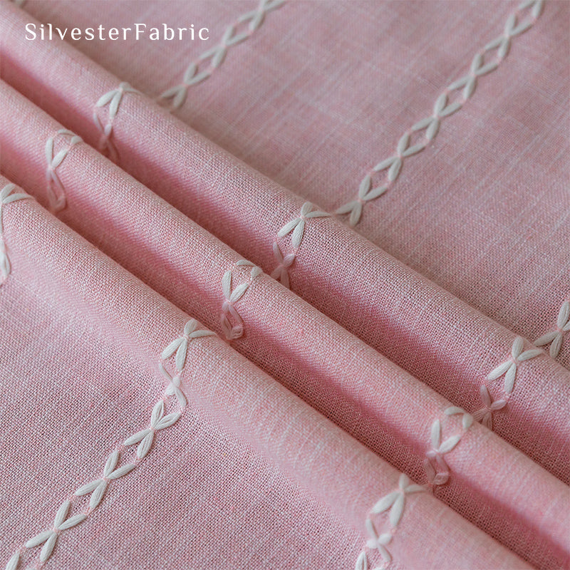 Light pink curtains hanging in the bedroom window