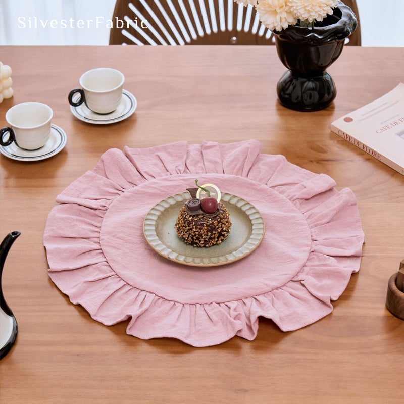 pink farmhouse round placemats styled with cutlery and glassware