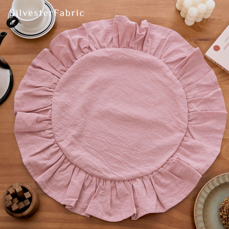 pink farmhouse round placemats laid flat on dining table