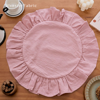 pink farmhouse round placemats laid flat on dining table