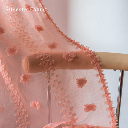 Pink sheer curtains hang on the bedroom window