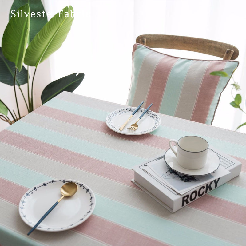 pink striped farmhouse tablecloth draped over rectangle table
