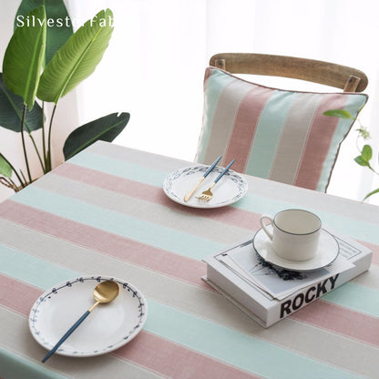 pink striped farmhouse tablecloth draped over rectangle table