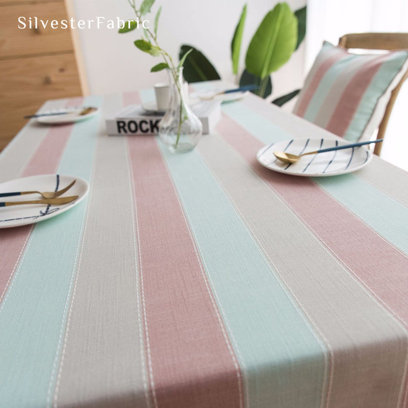 pink striped farmhouse tablecloth laid flat on dining table