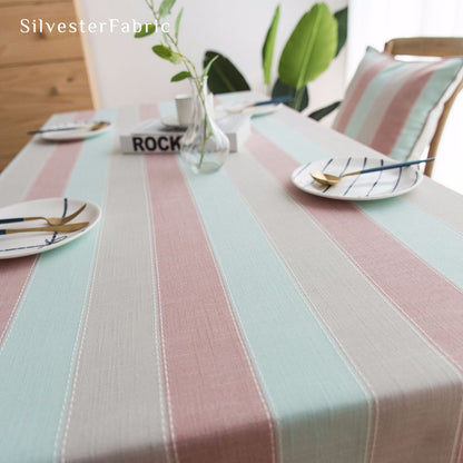 pink striped farmhouse tablecloth laid flat on dining table