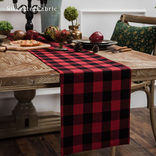 Red Christmas table runner on a wooden table