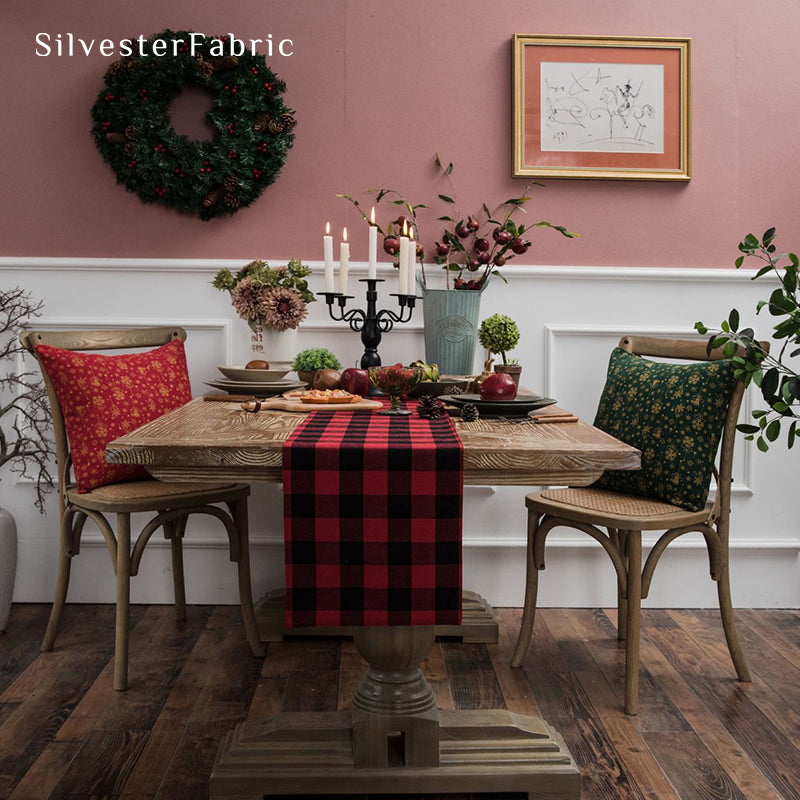 Red Christmas table runner on a wooden table