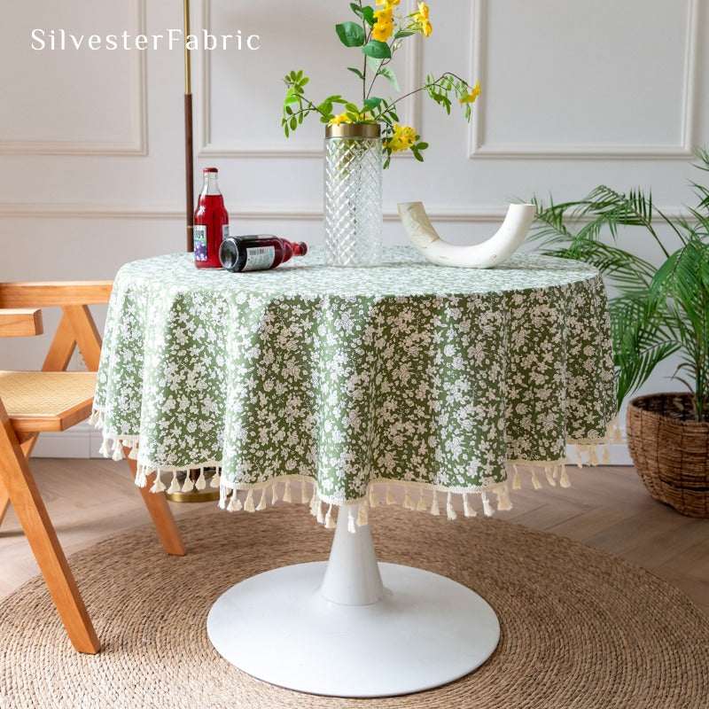 White floral print green tablecloth spread on table