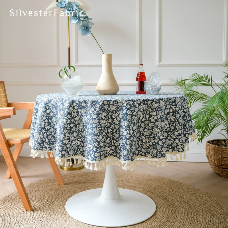White floral print blue tablecloth spread on table