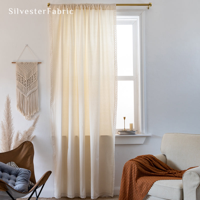 white farmhouse lace curtain hanging in window