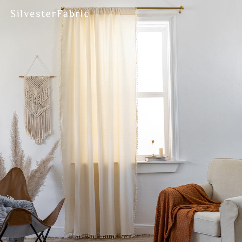 white farmhouse tassel curtain hanging in window