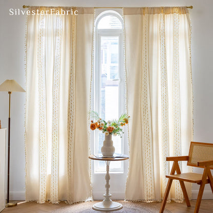 white crochet farmhouse curtain hanging in window