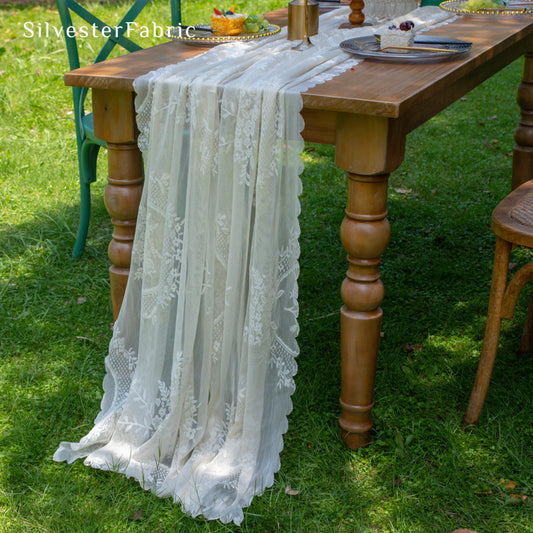 white lace table runner laid flat on dining table