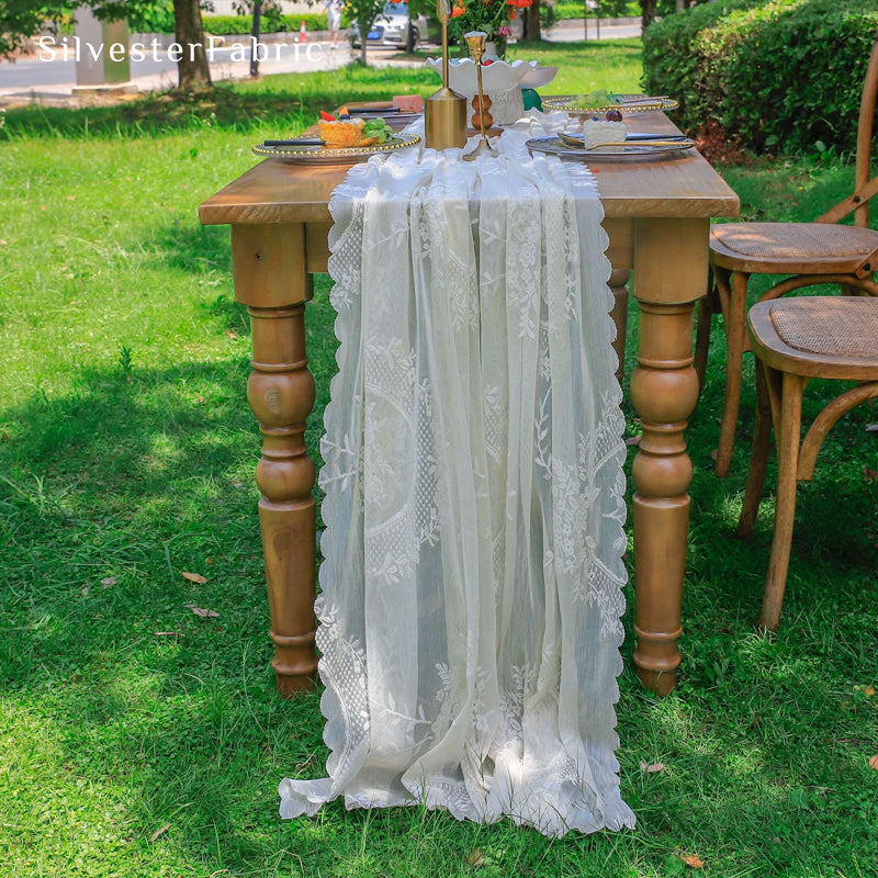 white lace table runner draped over rectangle table