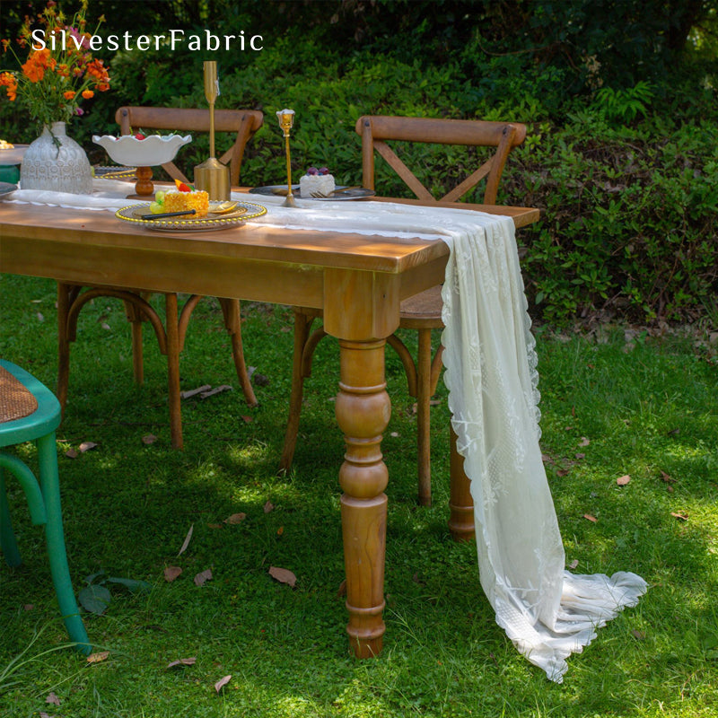 white lace table runner styled with plates and napkins