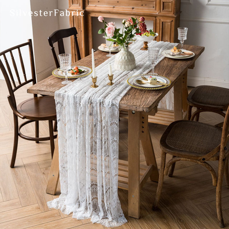 white lace table runner draped over rectangle table