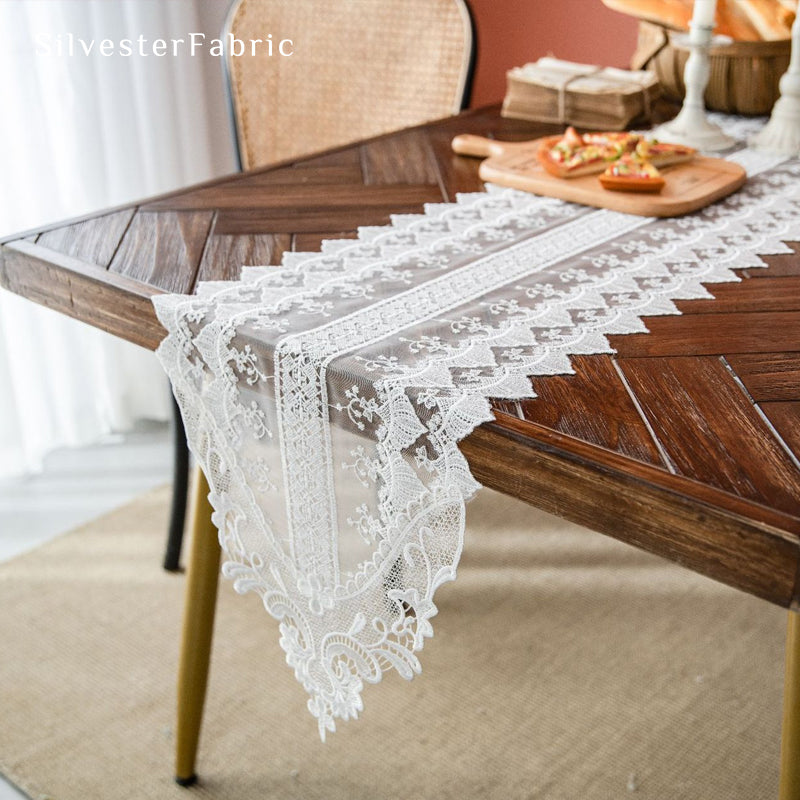 French lace table runner draped over rectangle table