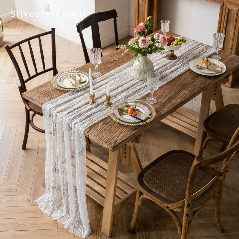 white floral lace table runner draped over rectangle table
