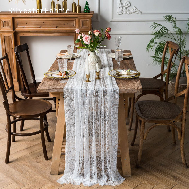 white lace table runner laid flat on dining table