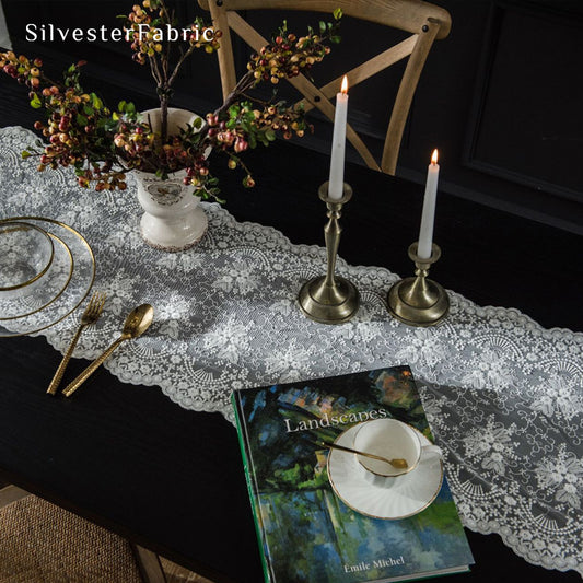 white lace table runner laid flat on dining table