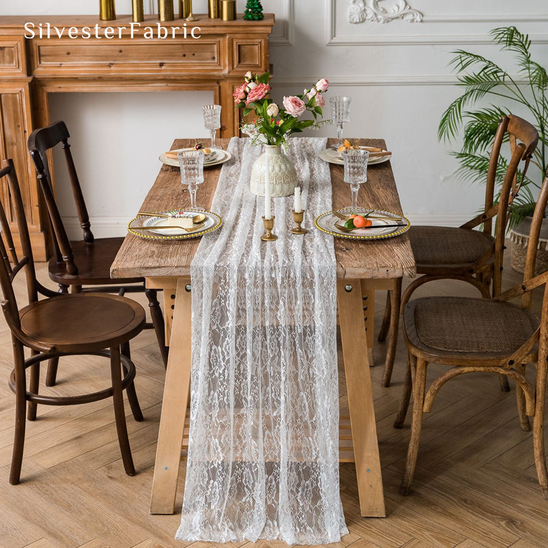 white floral lace table runner laid flat on dining table
