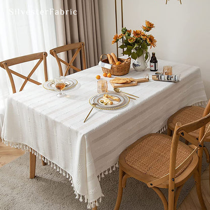 white embroidered striped tablecloth draped over rectangle table