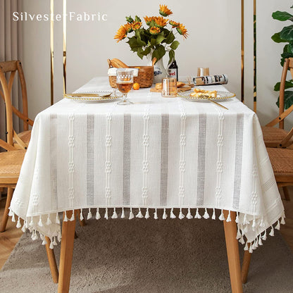 white embroidered striped tablecloth laid flat on dining table
