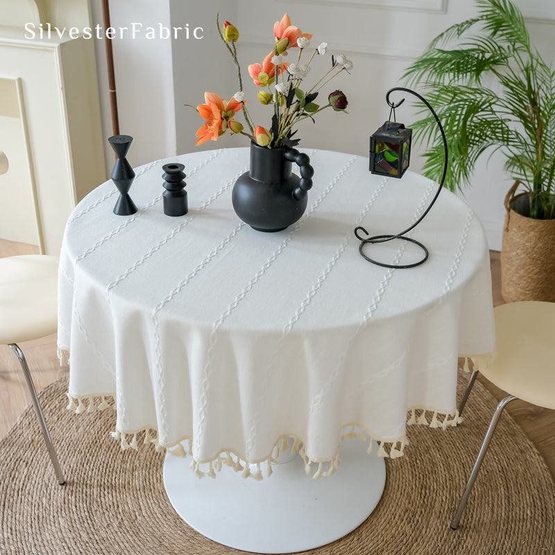 white farmhouse striped tablecloth draped over round table