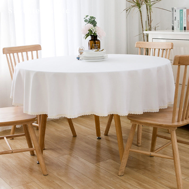 solid white farmhouse tablecloth draped over round table