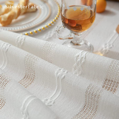 white embroidered striped tablecloth fabric close-up