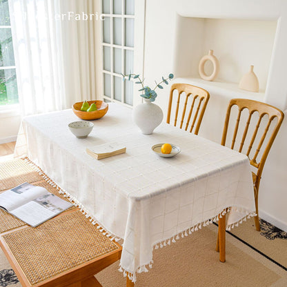 white plaid farmhouse tablecloth laid flat on dining table