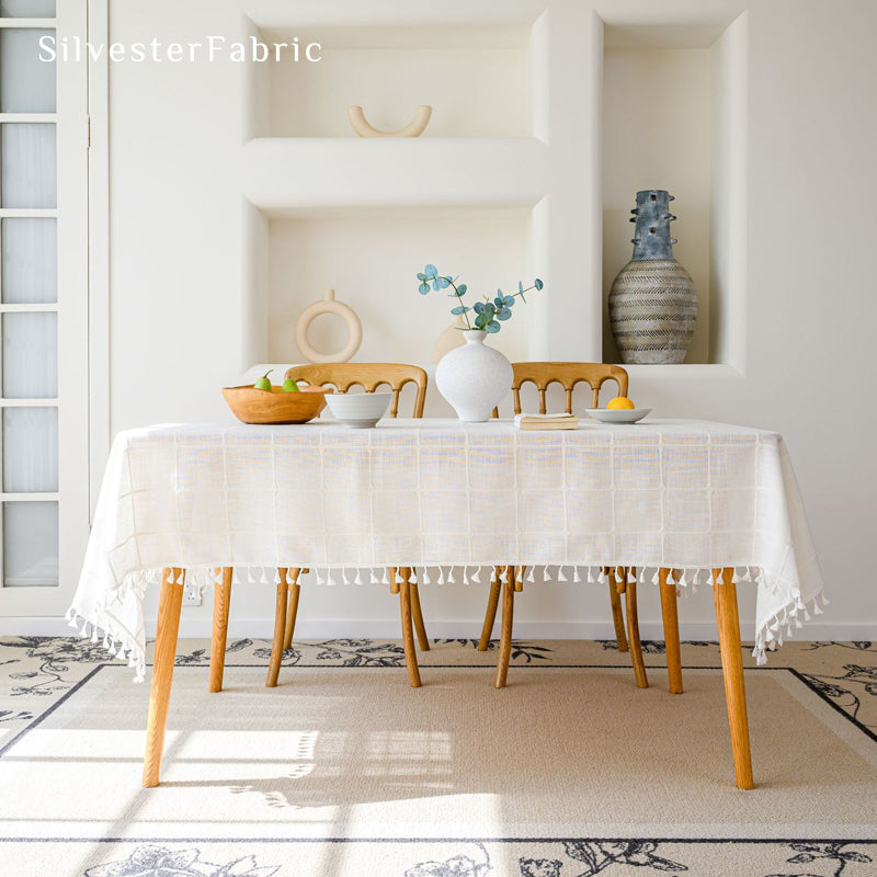 white plaid farmhouse tablecloth draped over rectangle table