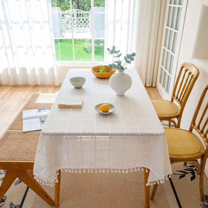 white plaid farmhouse tablecloth styled with plates and napkins
