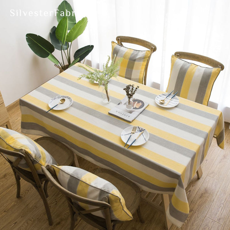 yellow striped farmhouse tablecloth draped over rectangle table