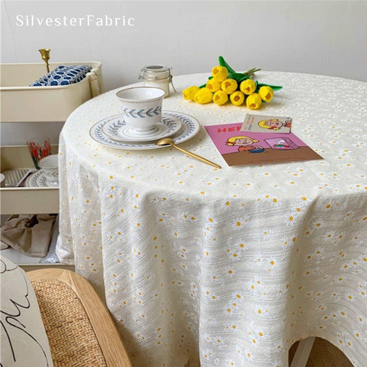 Spring daisy floral print tablecloth on a round table